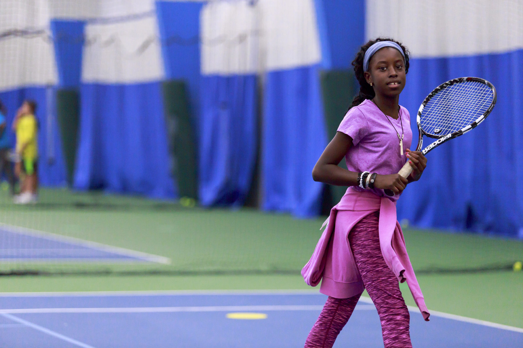 sports venues in montogmery parks. young woman playing indoor tennis