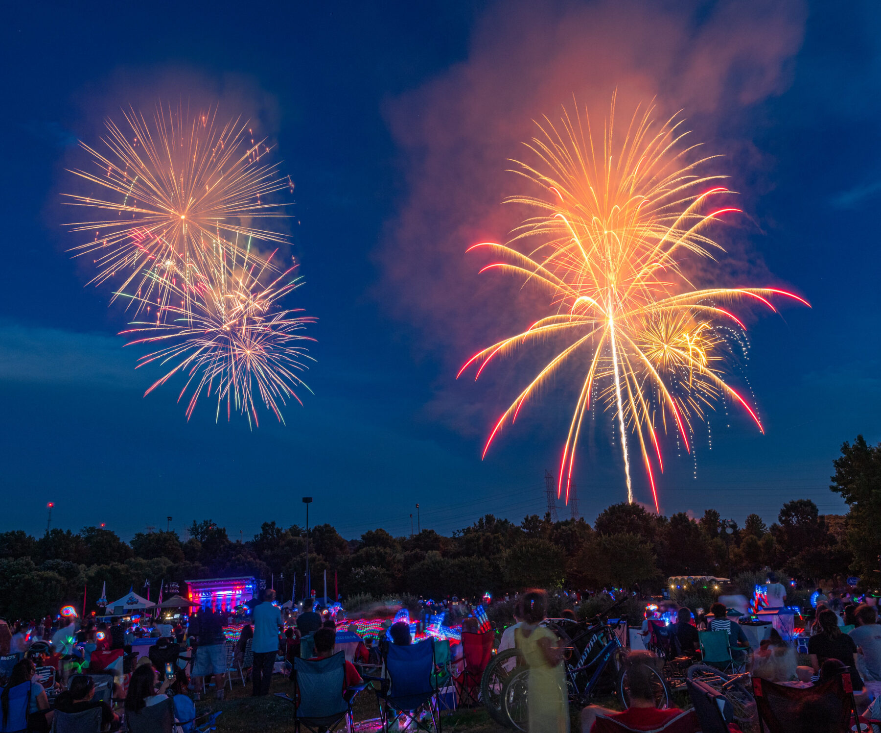 Colorful fireworks in the sky above a crowd