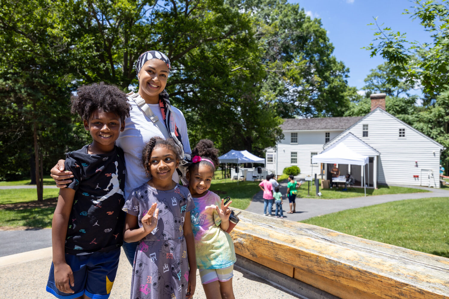 An family poses for a photo outside of Josiah Henson Museum and Park