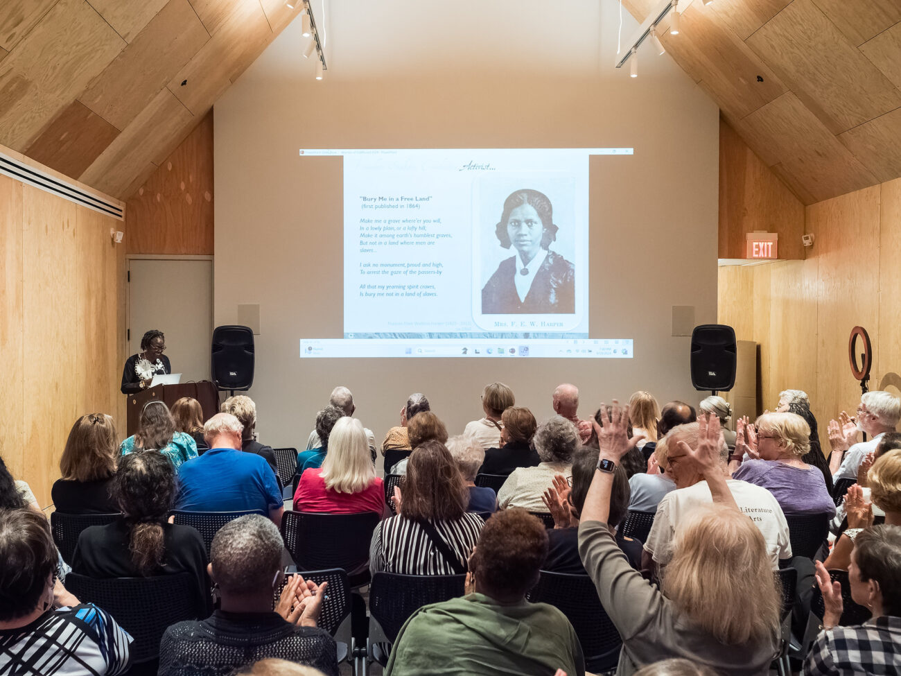 A crowd of people are seated in an auditorium for a History Hour lecture at Josiah Henson Museum and Park