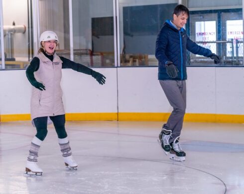 adults in an ice skating class