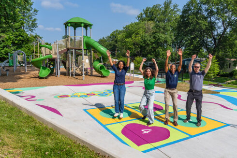Four people at Valleywood Neighborhood Park celebrating the new playground and art work at the park.