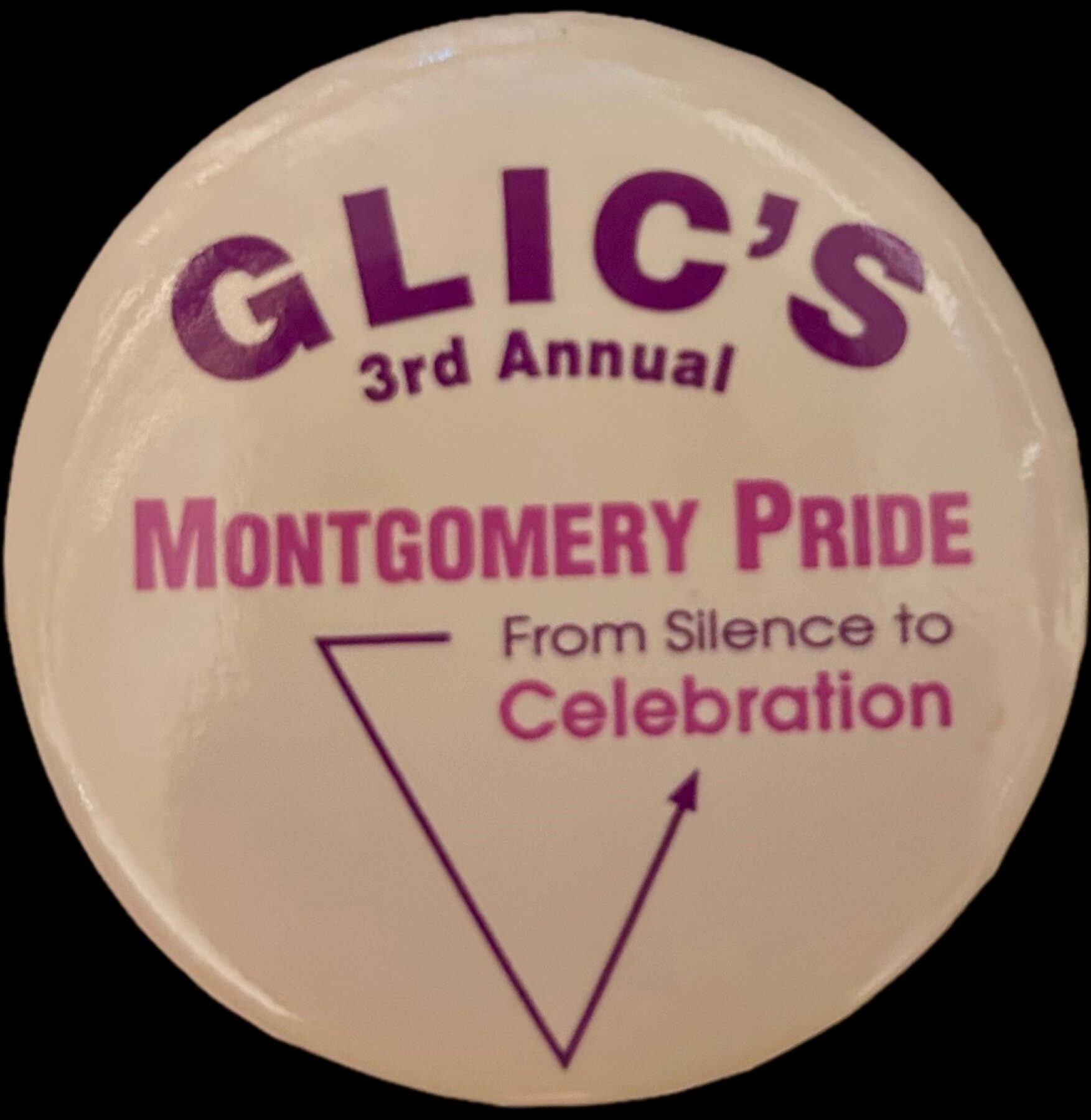 Crop of a photo of a button from the 3rd annual Montgomery County Pride day. The text shown reads "Montgomery Pride: From Silence to Celebration"