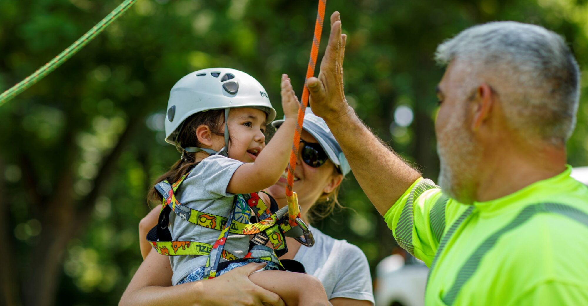 A child high fiving after climbing a tree
